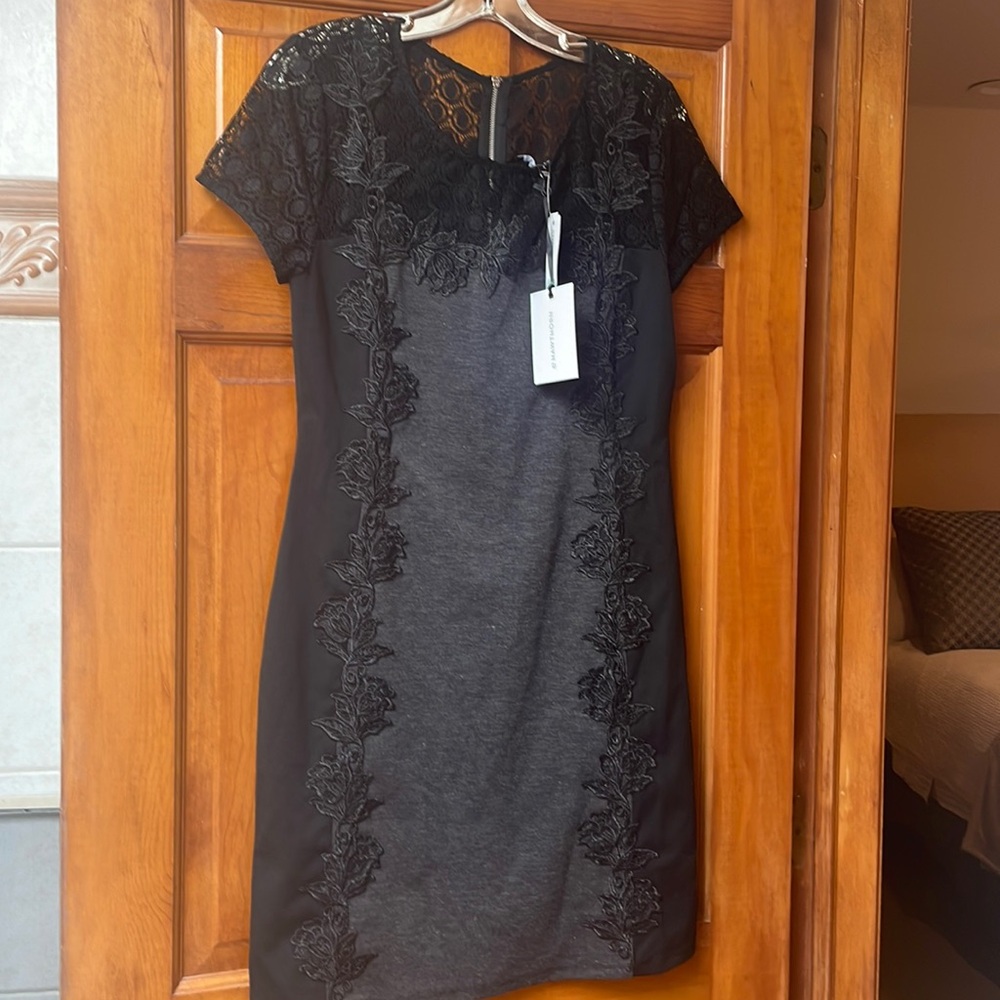 Beautiful never worn dress with forgiving fabric. Gives body beautiful curves.